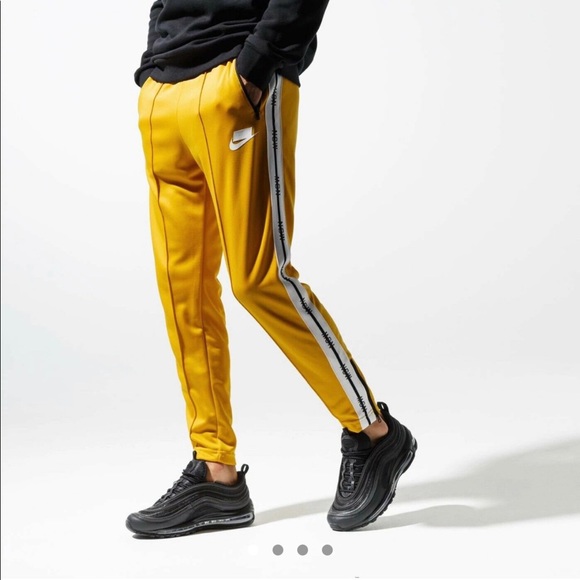 nike track pants yellow